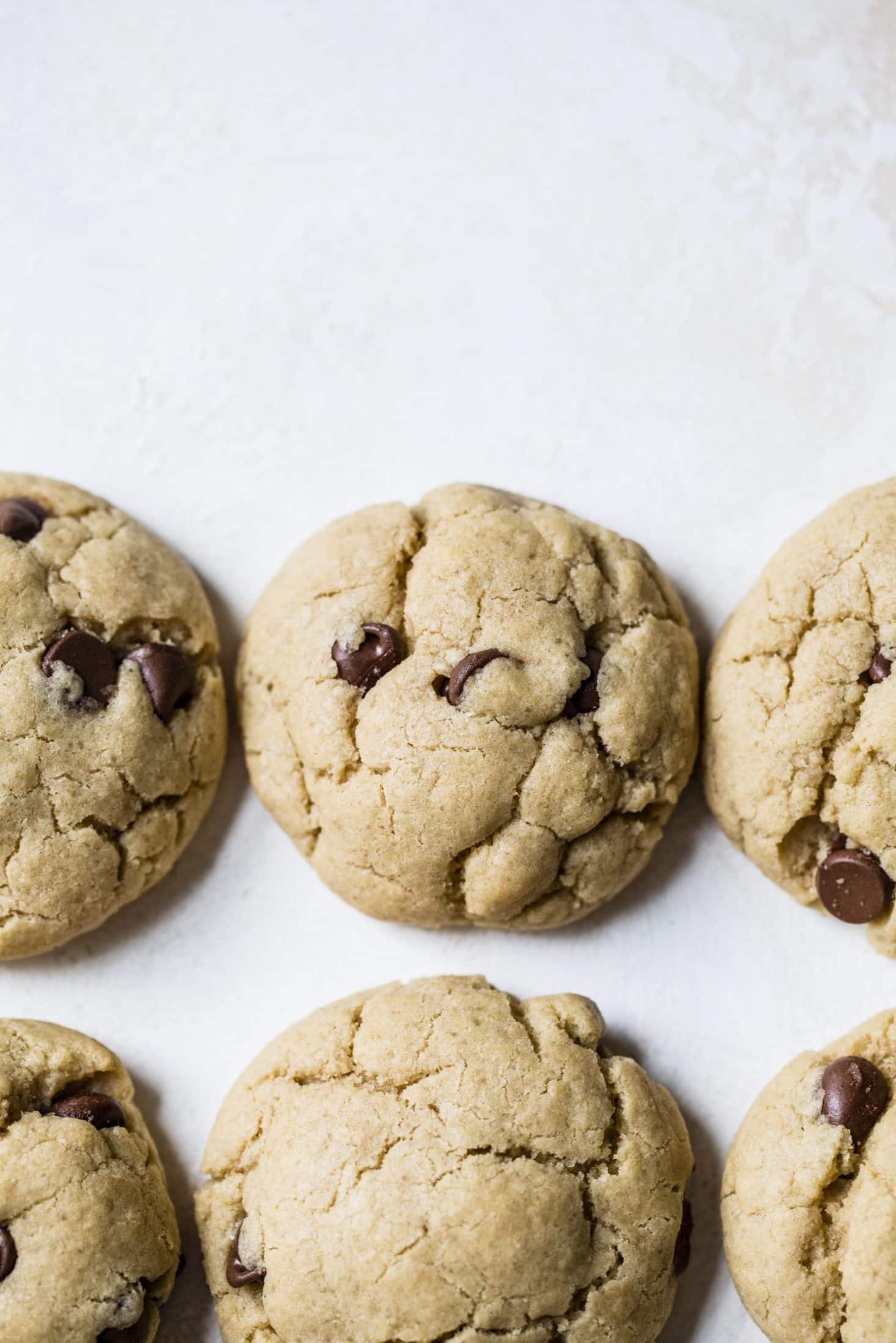 These puffy peanut butter cookies with chocolate chips are my most favorite peanut butter chocolate chip cookie ever! They are soft but also a little chewy and the combination is just to die for! Comes together super easily too. I howsweeteats.com #peanutbutter #cookies
