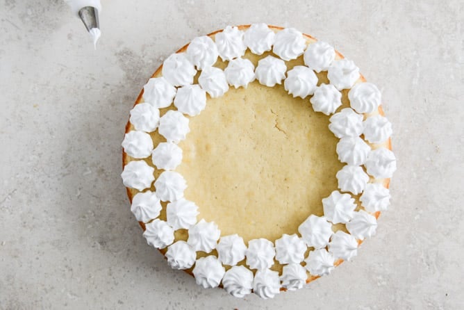 Easy Lemon Cake with Marshmallow Frosting + Toasted Coconut I howsweeteats.com Easy Lemon Cake with Marshmallow Frosting + Toasted Coconut I howsweeteats.com