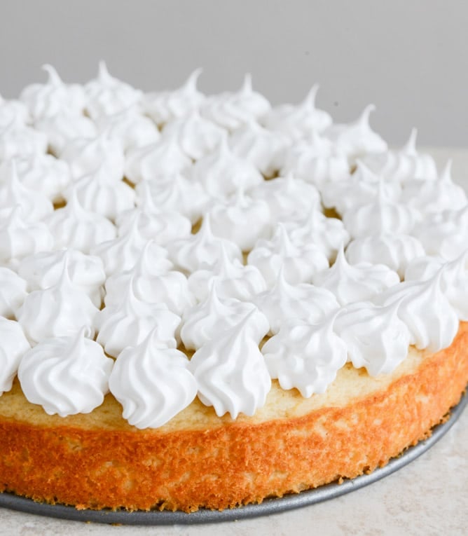 Easy Lemon Cake with Marshmallow Frosting + Toasted Coconut I howsweeteats.com Easy Lemon Cake with Marshmallow Frosting + Toasted Coconut I howsweeteats.com