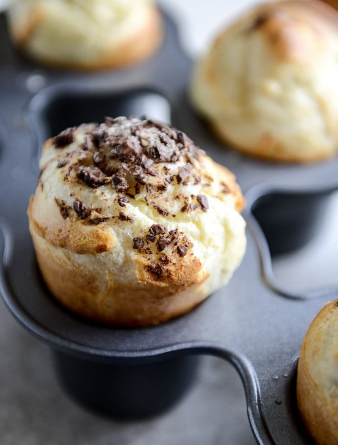 Dark Chocolate Chunk Popovers with Spiked Vanilla Bourbon Whipped Cream I howsweeteats.com Dark Chocolate Chunk Popovers with Spiked Vanilla Bourbon Whipped Cream I howsweeteats.com
