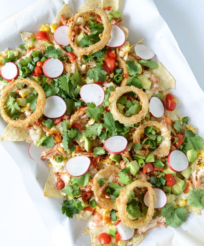 summer BBQ chicken nachos with buttermilk onion rings and white cheddar queso I howsweeteats.com