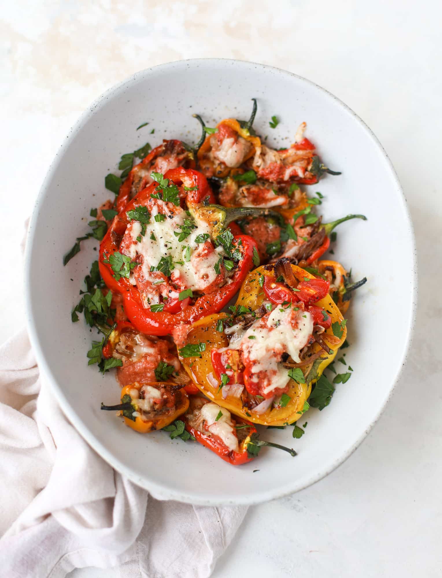 These pulled pork stuffed peppers are a delicious dinner idea for any weeknight! They work great with leftover pulled pork and the filling is totally customizable. They are flavorful, come together quickly and always a crowd pleaser! I howsweeteats.com #pulledpork #stuffedpeppers