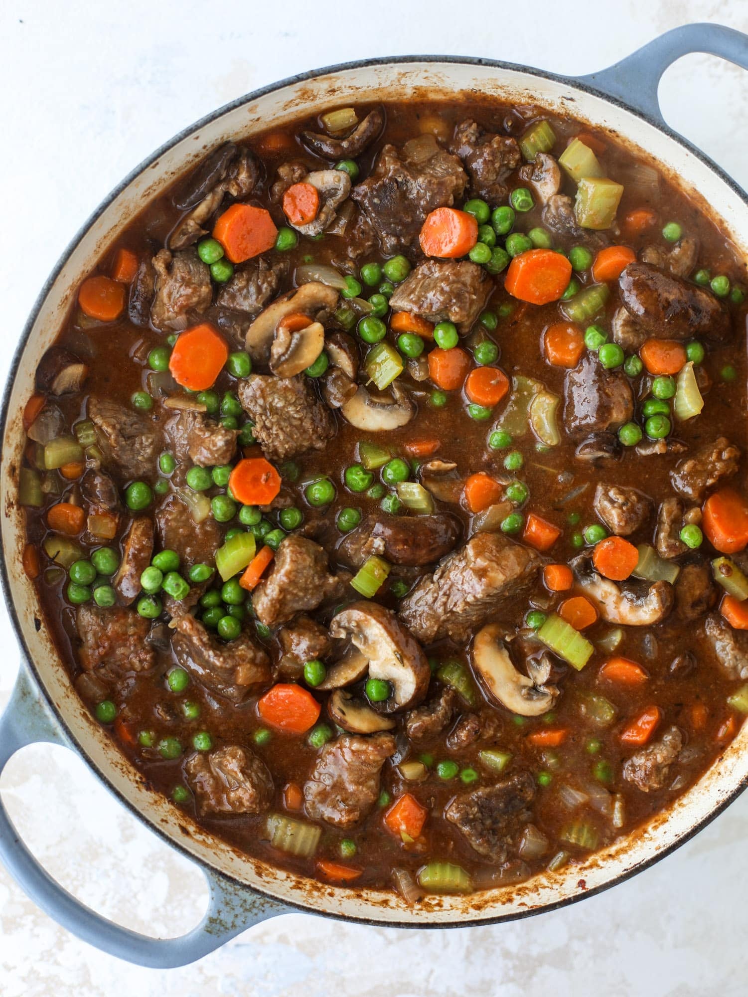 A perfect cold weather comfort food meal, Guiness pot pie has tender, fall-apart beef, lots of vegetables and is topped with buttery beer bread biscuits! I howsweeteats.com #guinness #potpie