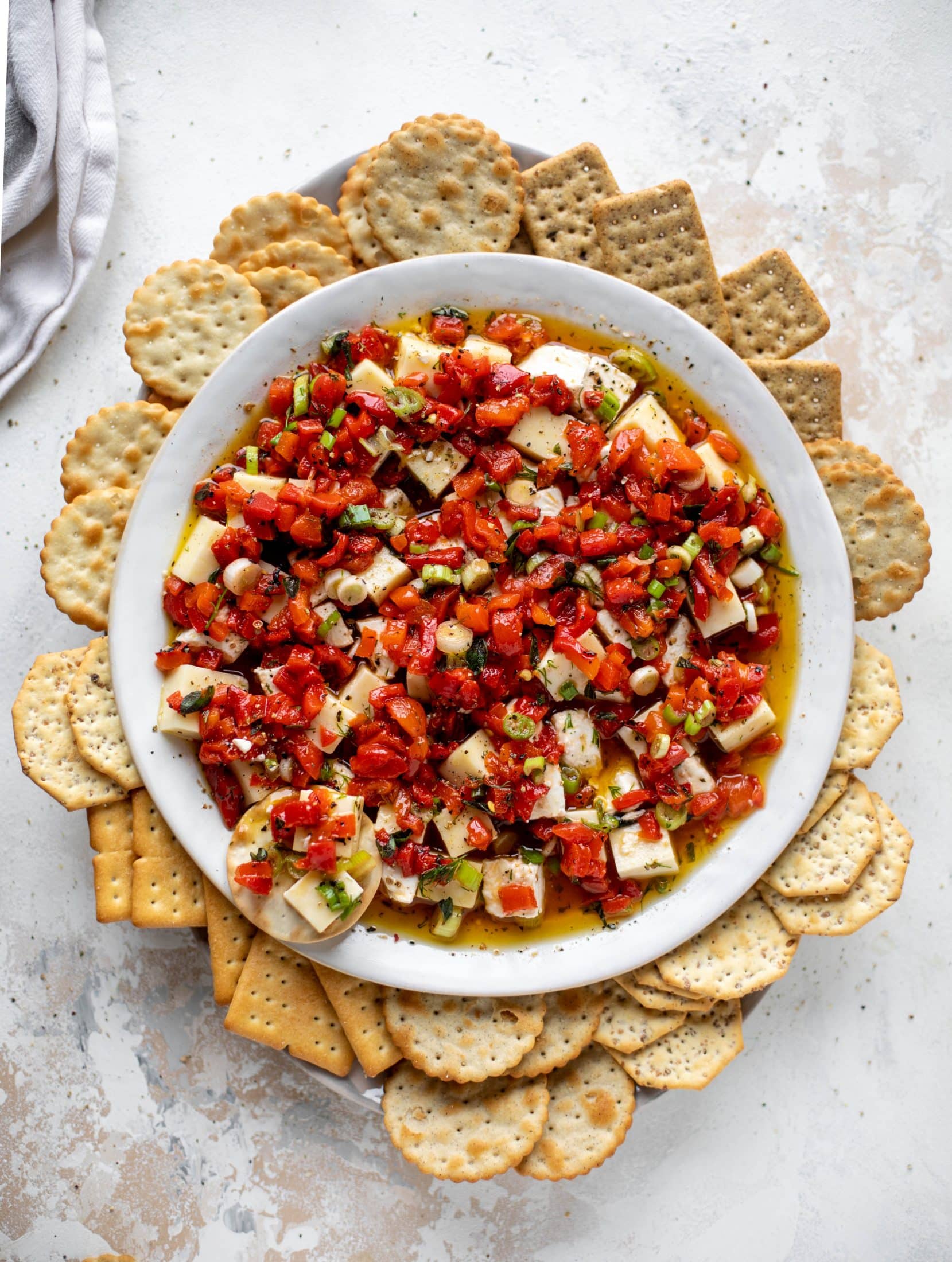 This marinated cheese recipe is perfect for Christmas! Make it ahead and transport it easily to your destination. It's absolutely delicious.