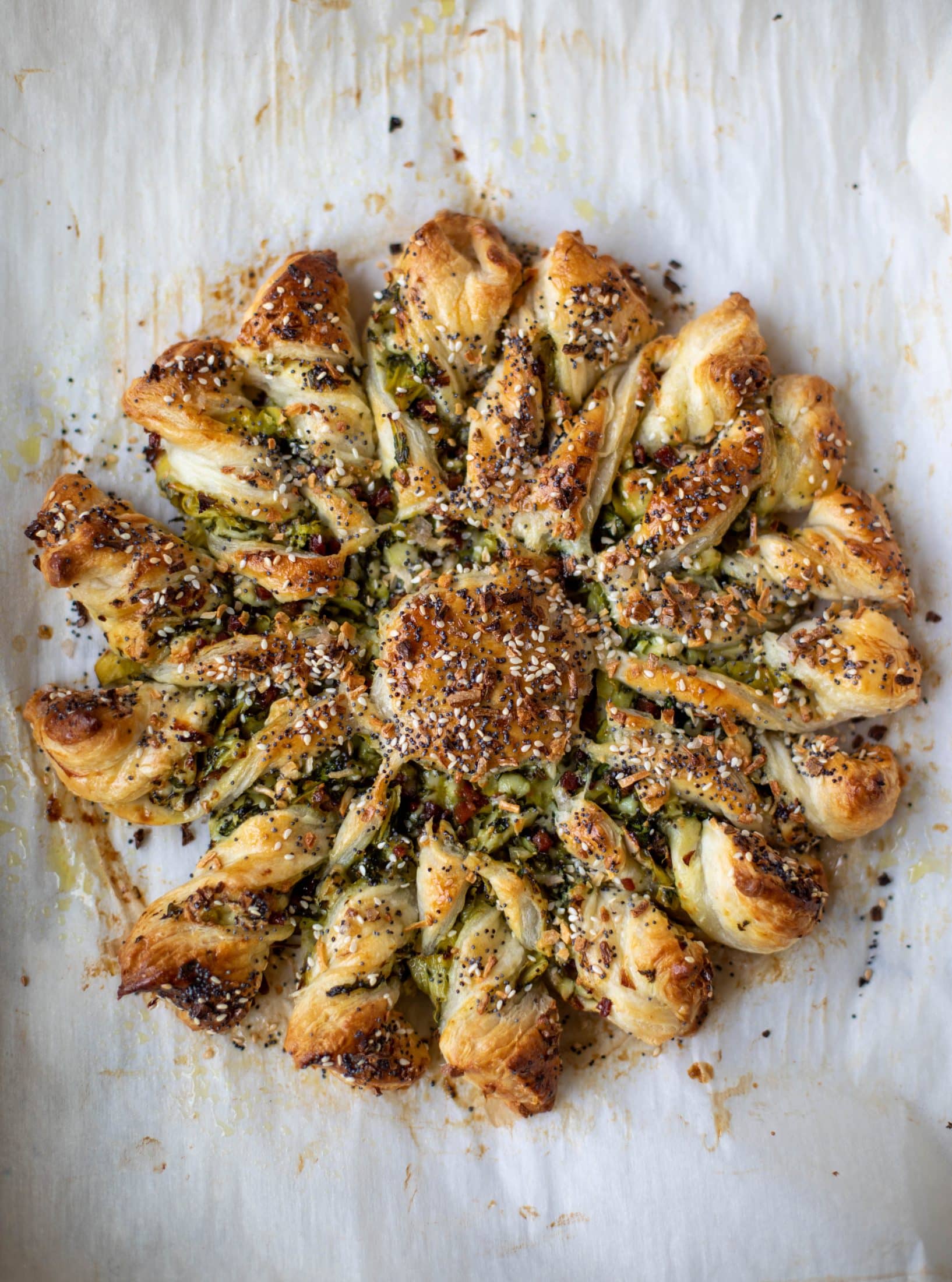 These spinach artichoke twists are filled with cheese and pancetta. They are buttery and flaky on the outside then sprinkled with everything seasoning. YUM.