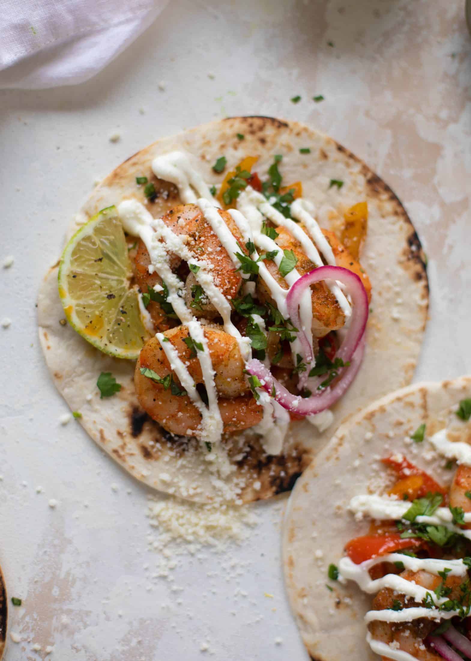 These lime sheet pan shrimp fajitas are the best weeknight meal! Make everything on the sheet pan and serve in warm tortillas. Delicious!