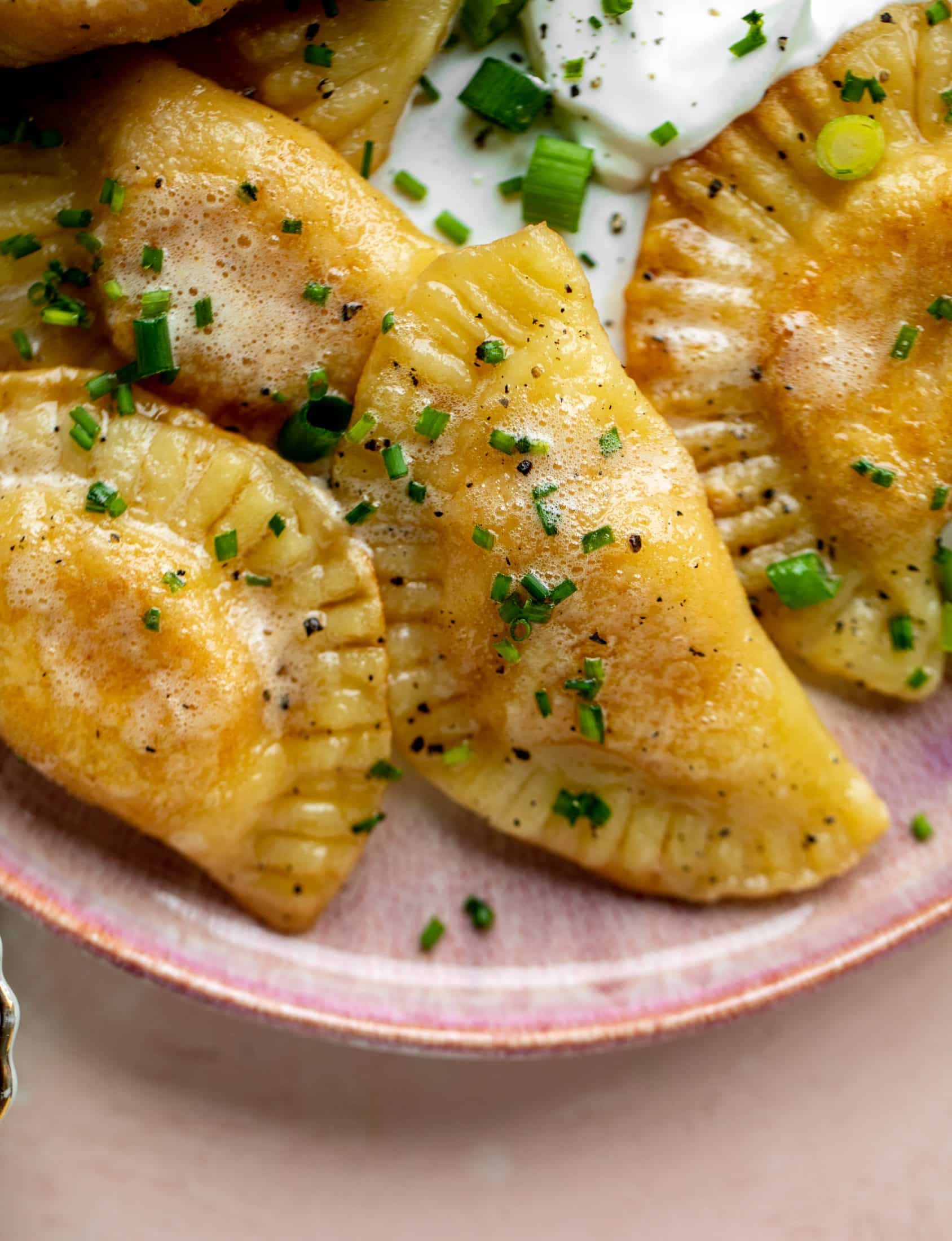 The most delicious sweet potato pierogi recipe! Roasted sweet potato and fontina cheese in pillowy dough. Make sure to serve with brown butter!