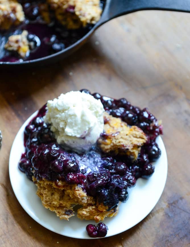 Skillet Blueberry Cobbler with a Cheddar Biscuit Crust I howsweeteats.com Skillet Blueberry Cobbler with a Cheddar Biscuit Crust I howsweeteats.com