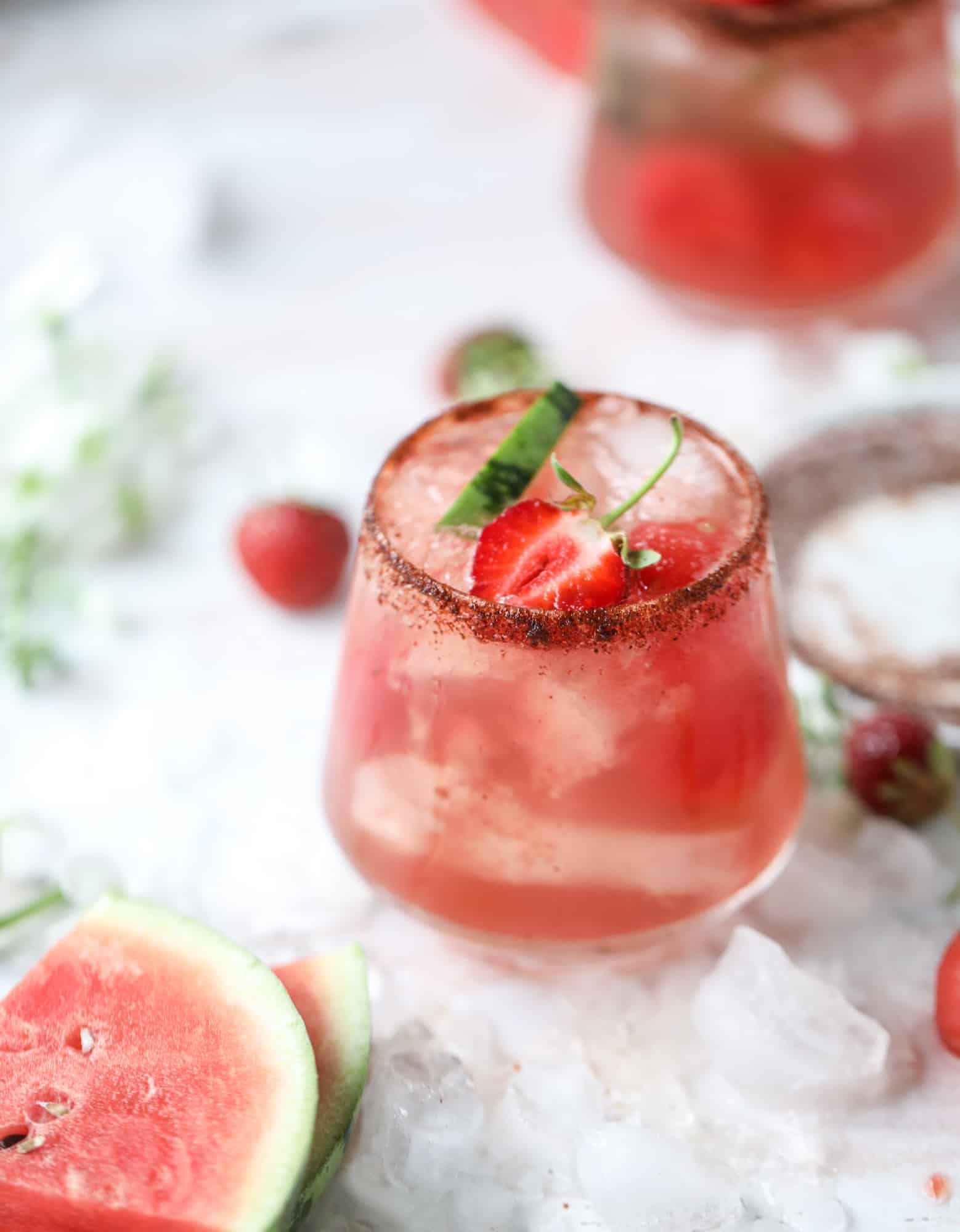 This spicy watermelon sangria is super refreshing, light, delicious and perfect for a hot summer day! Complete with an entire bottle of rosé, watermelon juice, melon balls, strawberries and brandy, this is the best summer cocktail in a pitcher! I howsweeteats.com #spicy #watermelon #sangria #cocktails #rosé