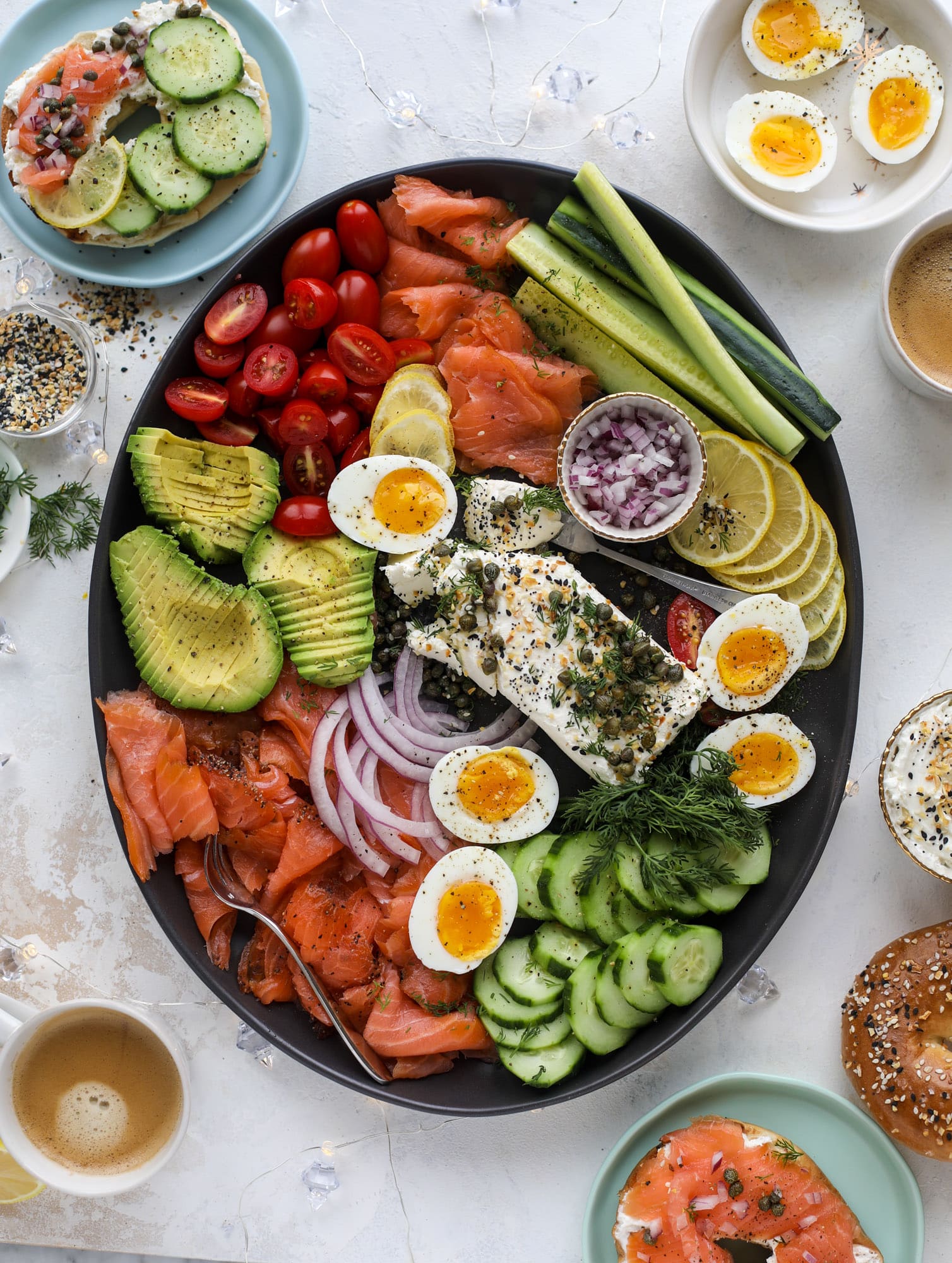 This is my favorite way to make an incredible smoked salmon platter! Fresh smoked salmon with bagels, soft boiled eggs, cream cheese and capers, everything seasoning and so much more. Perfect for holiday breakfasts and brunches! I howsweeteats.com #smokedsalmon #platter