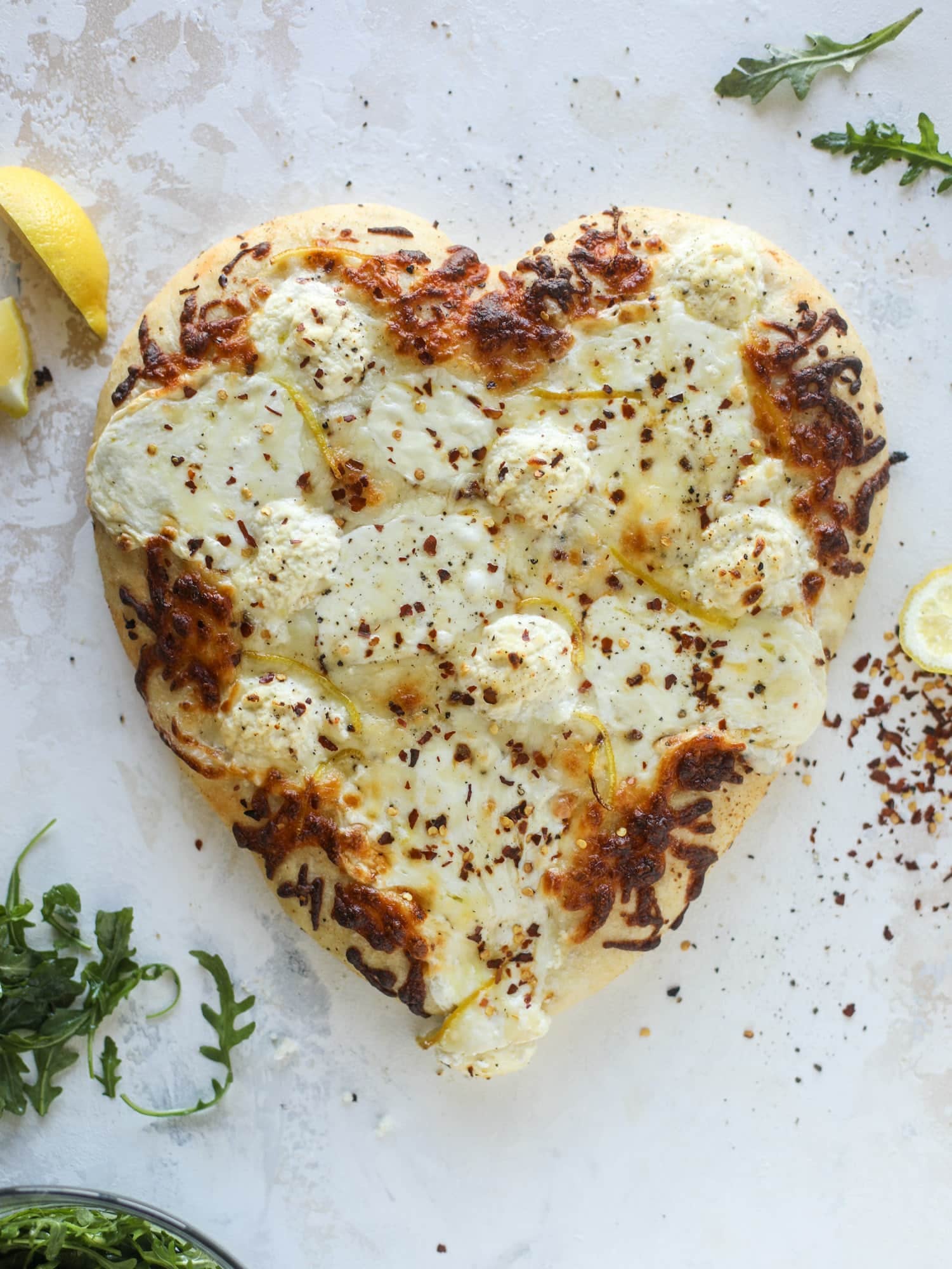 Our favorite white pizza recipe has four different kinds of cheese and comes on a garlic bread crust! Topped with crushed pepper and lemon - tons of flavor! I howsweeteats.com #white #pizza