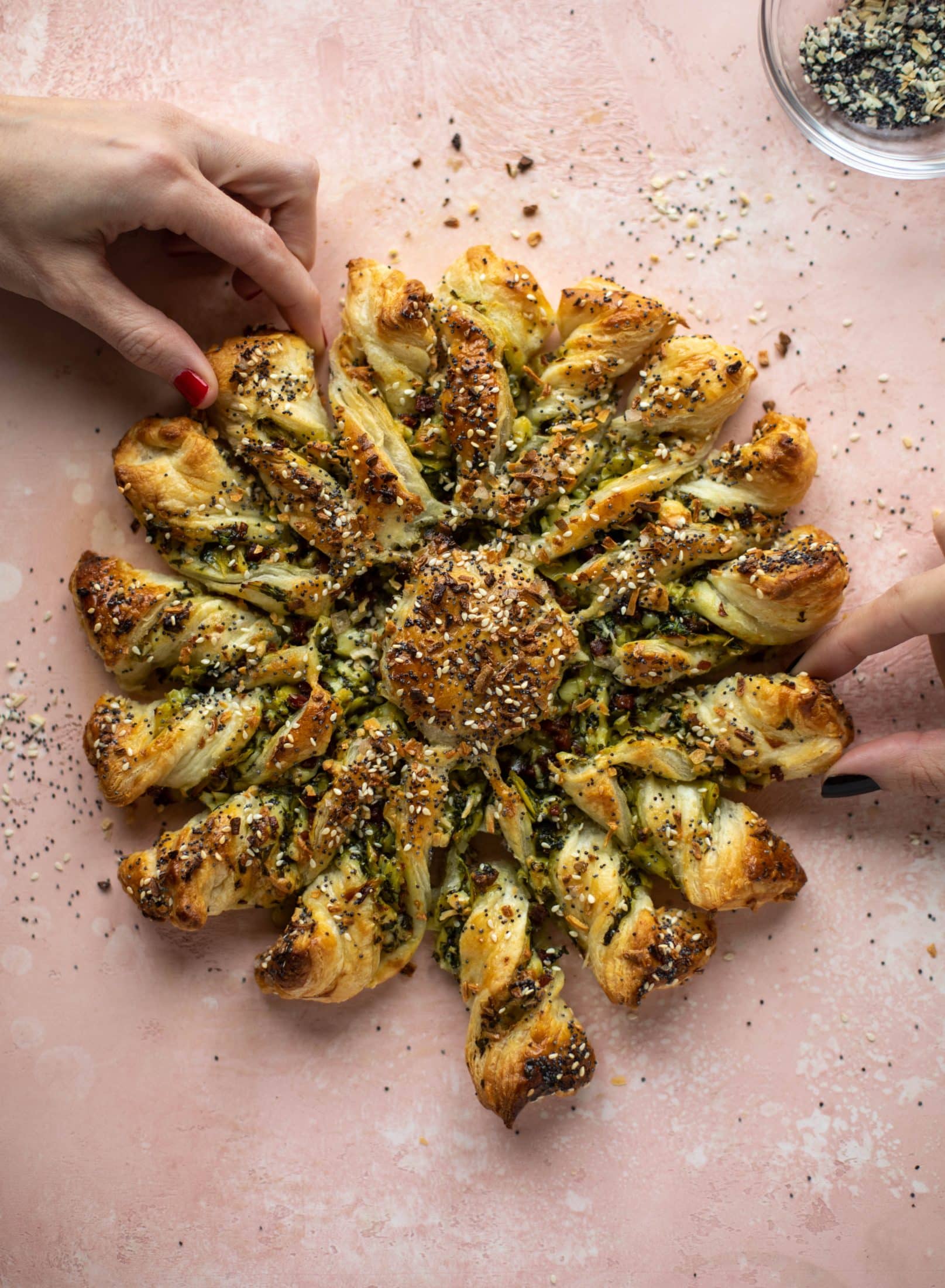 These spinach artichoke twists are filled with cheese and pancetta. They are buttery and flaky on the outside then sprinkled with everything seasoning. YUM.