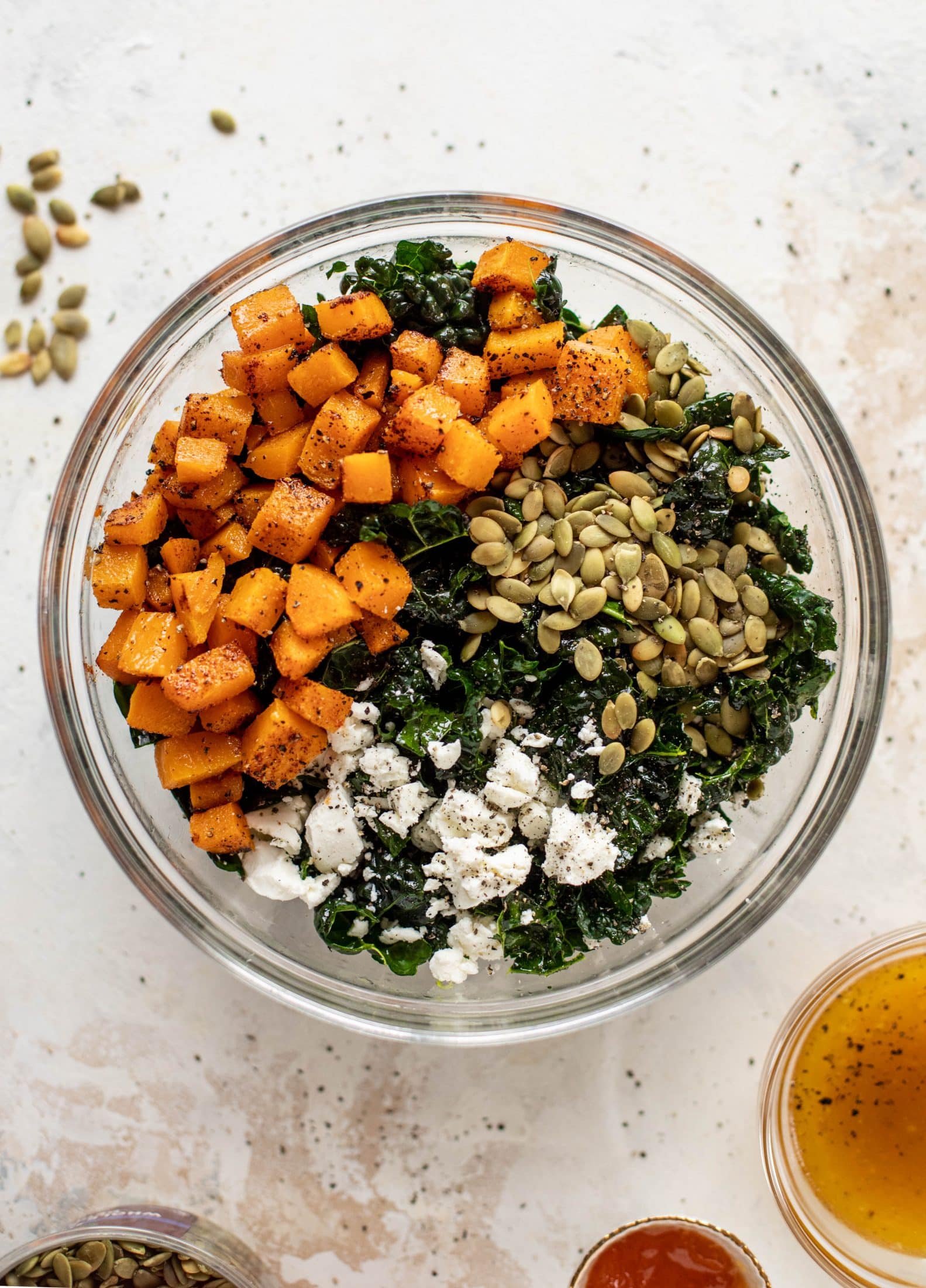 This butternut squash kale salad is so easy and delicious! Roasted, smoky butternut squash, goat cheese, pepitas and apricot vinaigrette.