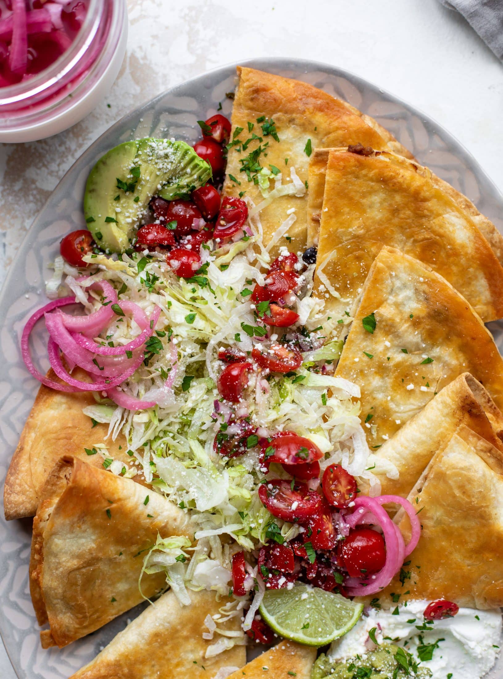 These crispy baked quesadillas will change your life! Make a big batch at once using pantry ingredients and your favorite cheese. 