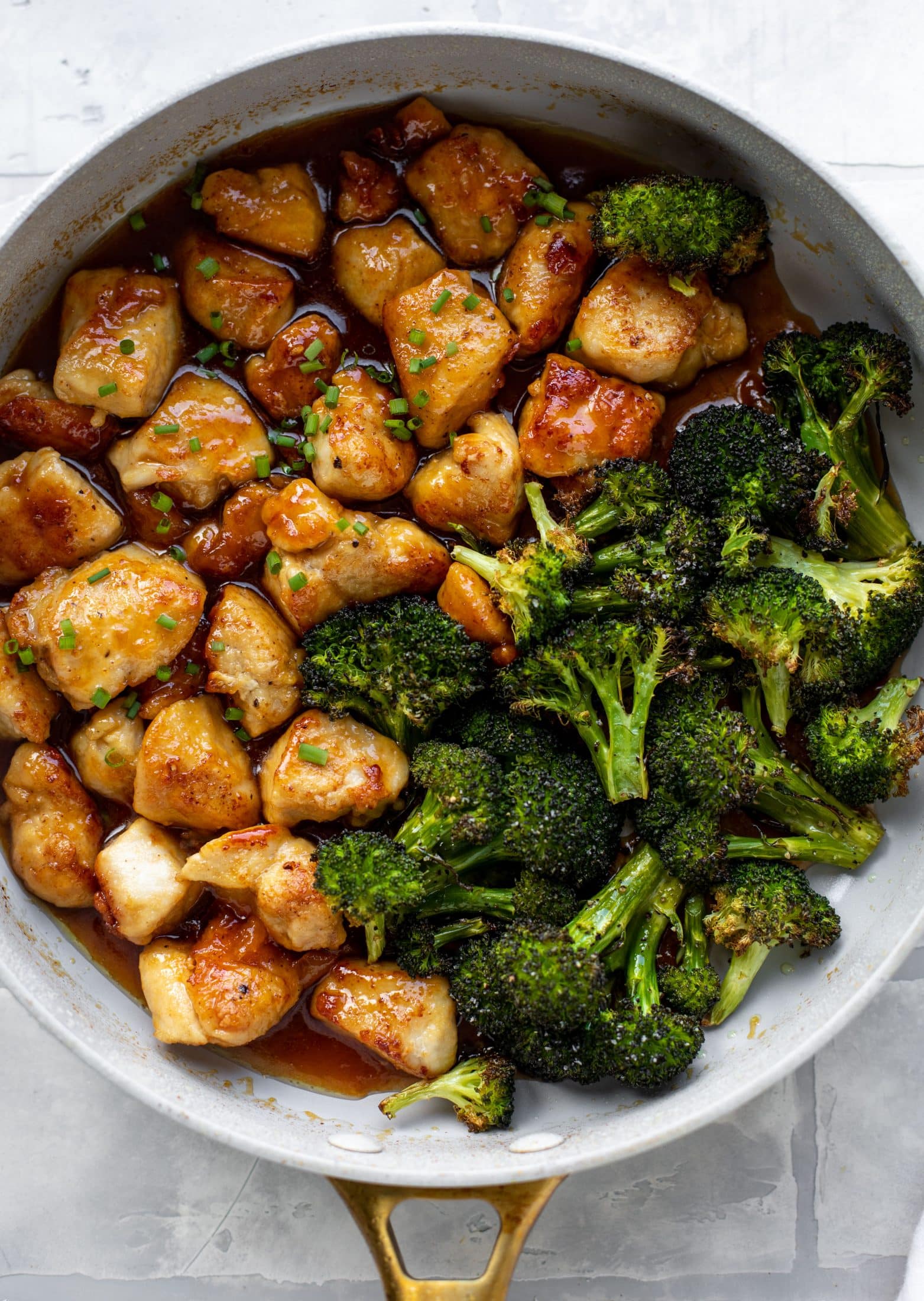 This sticky apricot chicken is so juicy and delicious! The chicken is seared and glazed with a jammy apricot sauce. Serve with broccoli and rice!
