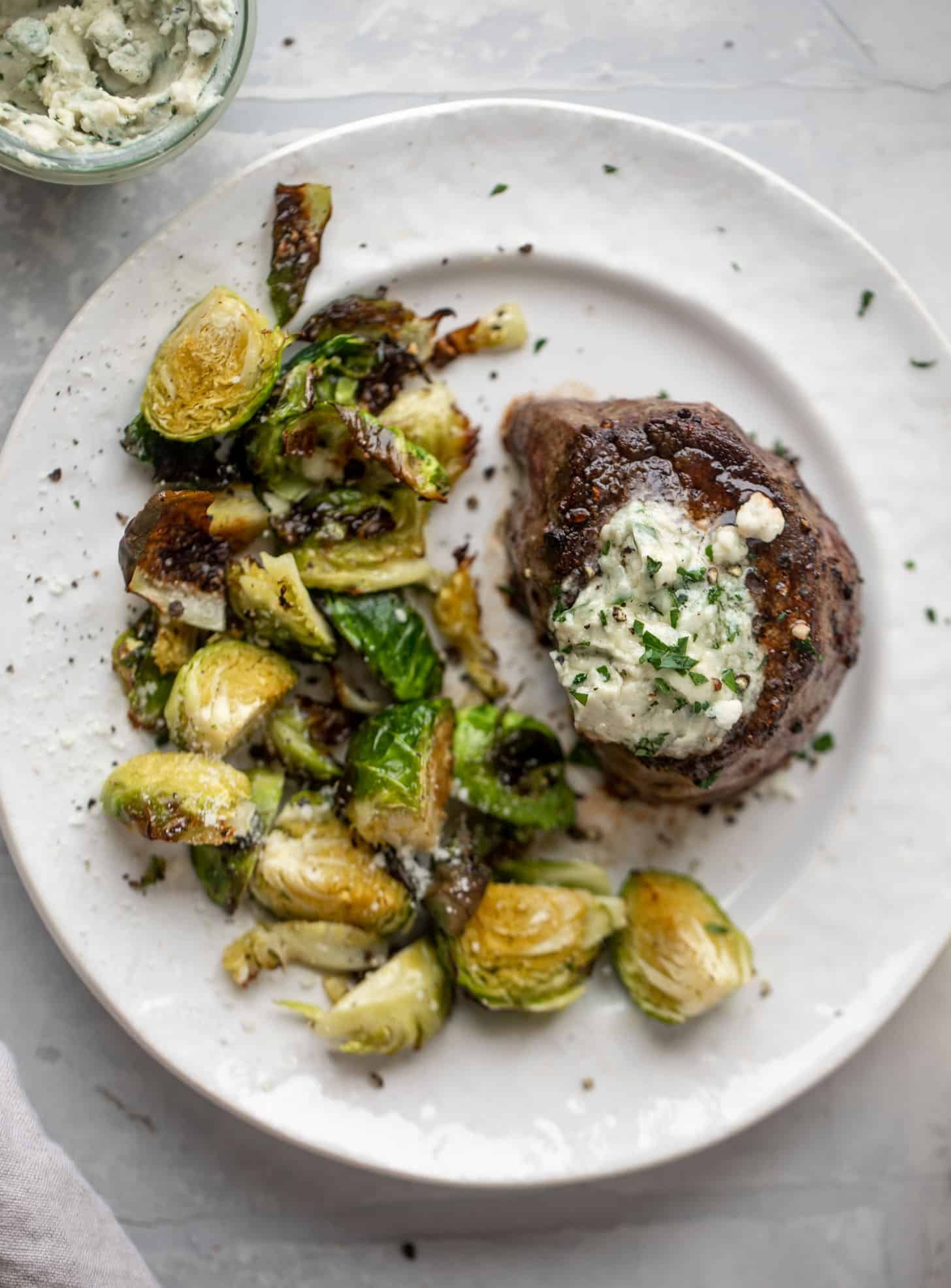filet mignon with blue cheese butter and cacio e pepe brussels