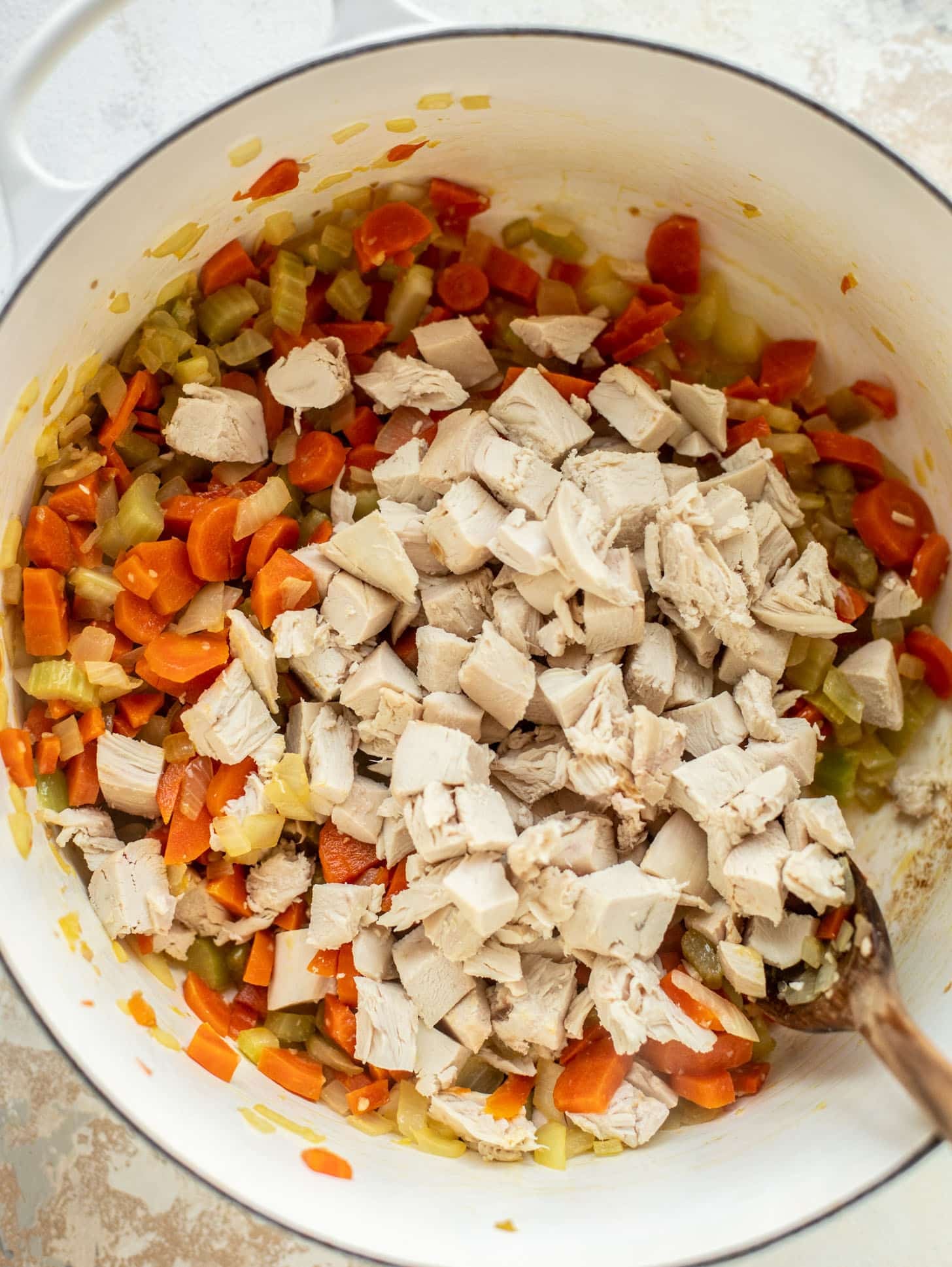 celery, onions, carrots, ginger, garlic and chicken in a pot