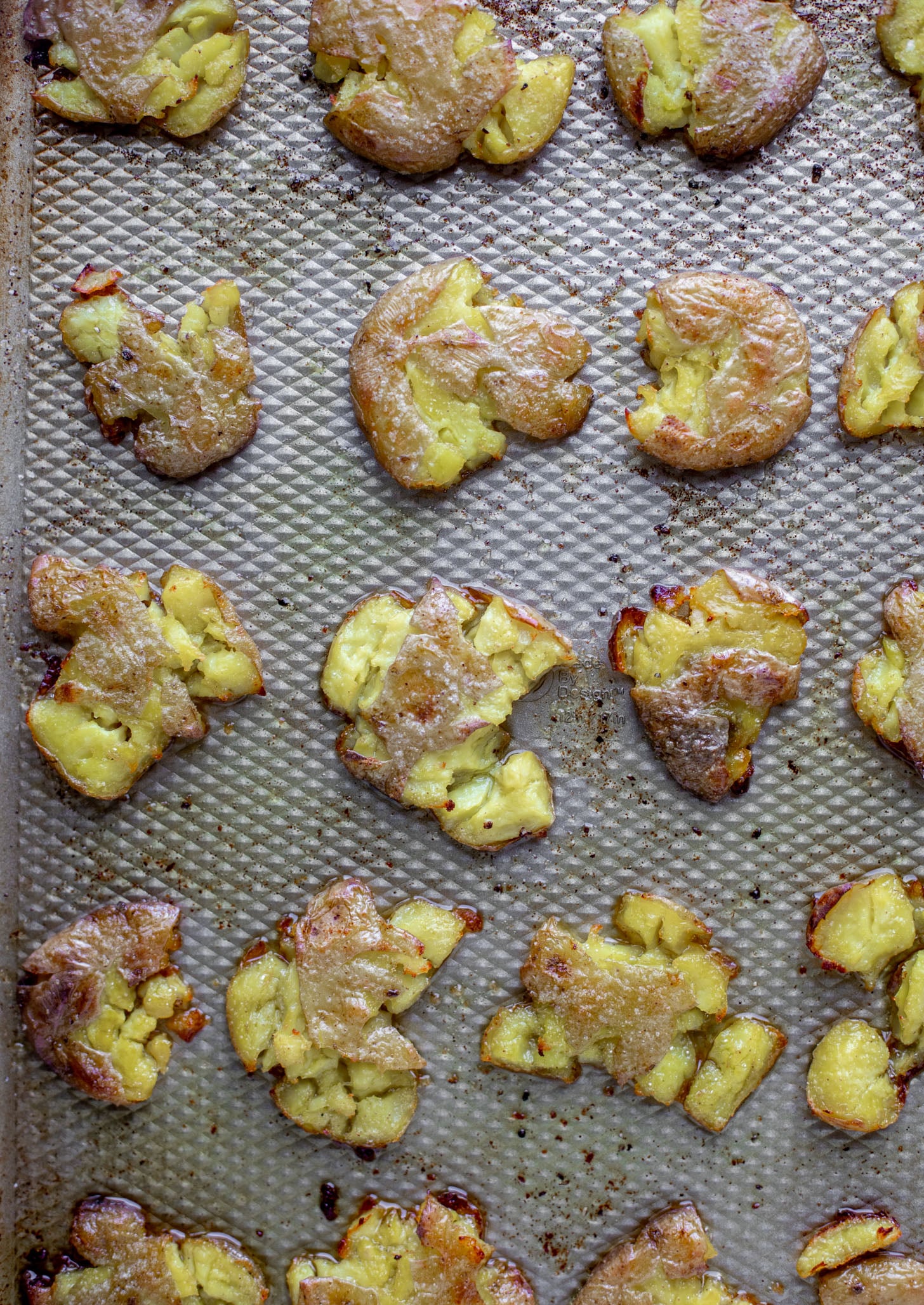 smashed potatoes on baking sheet